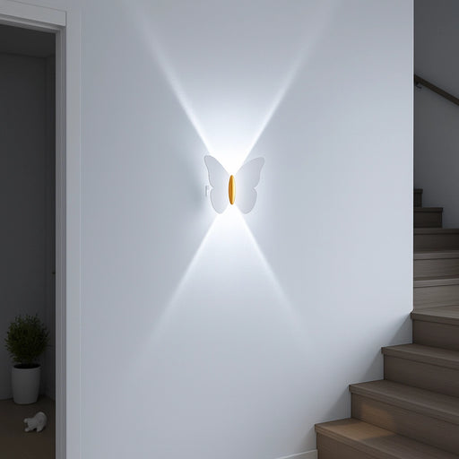 Modern wall sconce lighting fixture on a white wall with stairs in the background