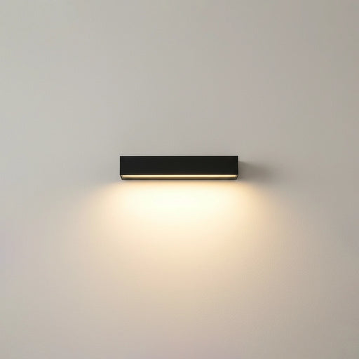 Modern wall-mounted light fixture on a plain wall
