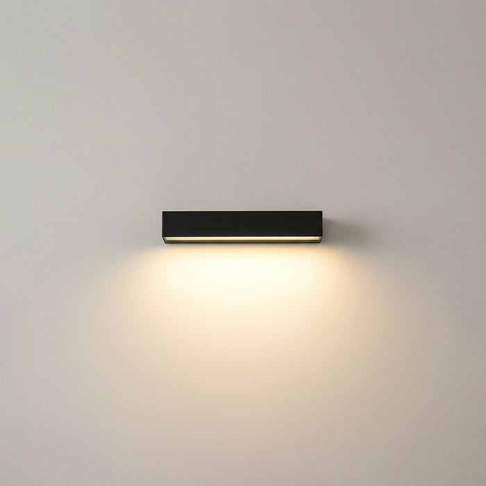 Modern wall-mounted light fixture on a plain wall