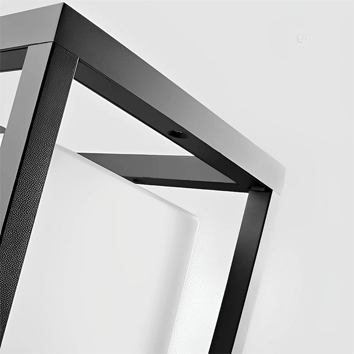 Close-up of a modern black metal shelf against a white background