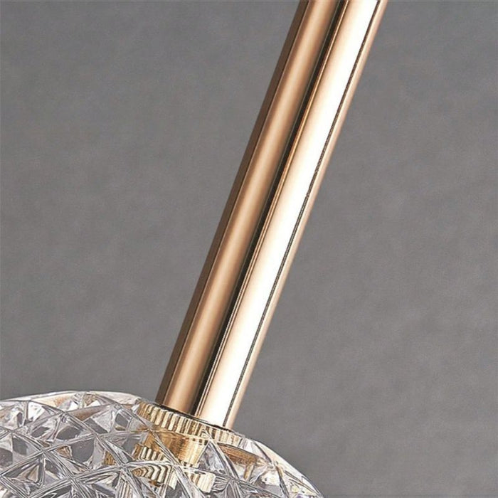 Close-up of a gold and crystal decorative item against a gray background