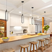 Modern kitchen with wooden counter, stools, and pendant lights.