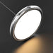 Round metallic light fixture on a dark background