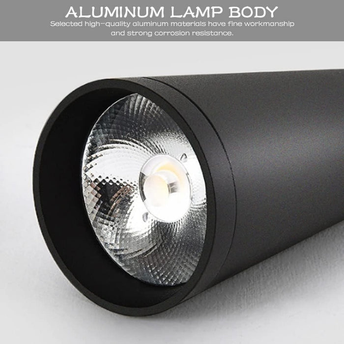 Black spotlight with metallic lens on a light gray background