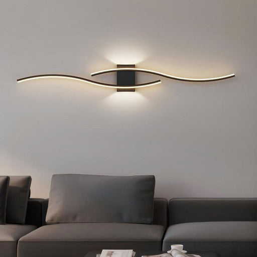Modern wall light fixture in a living room setting with a gray sofa.
