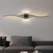 Modern wall light fixture in a living room setting with a gray sofa.
