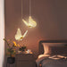 Butterfly-shaped pendant lights in a bedroom setting with a warm ambiance.