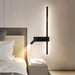 Modern wall-mounted light fixture in a bedroom setting.