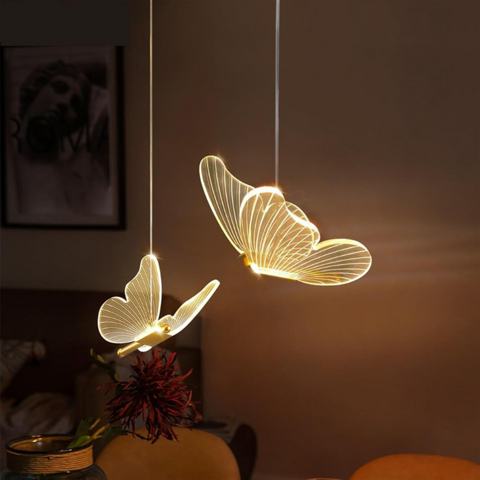 Butterfly-shaped pendant lights hanging in a room with a blurred background