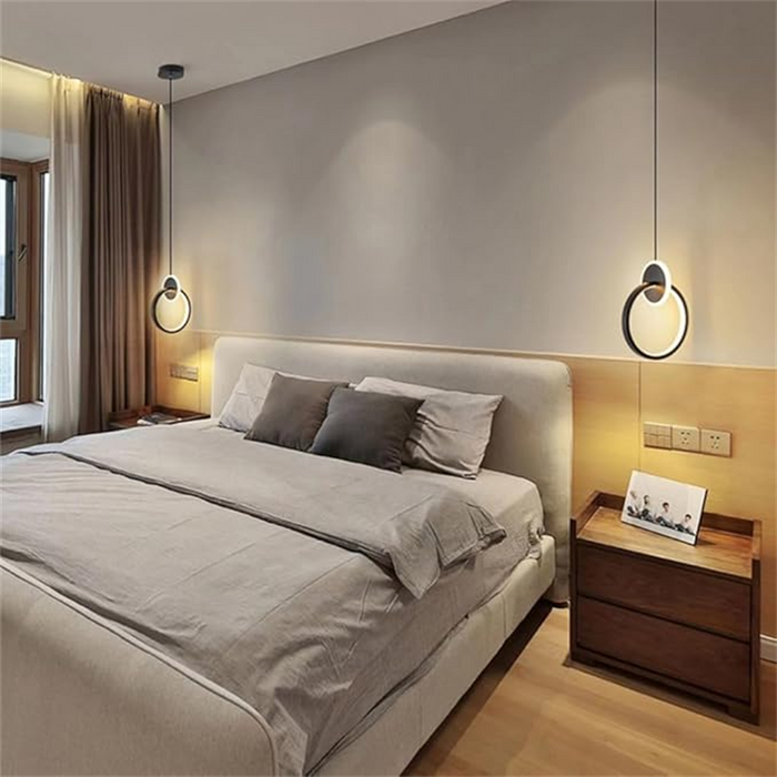 Modern bedroom with a bed, nightstands, and wall lights.