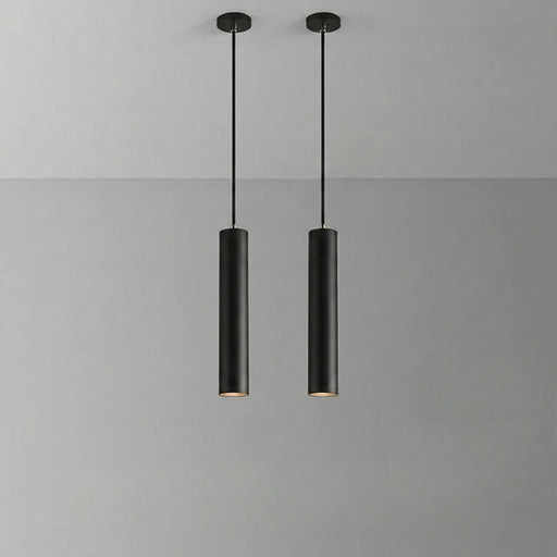 Two black pendant lights hanging against a gray background