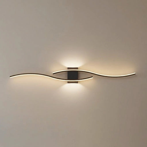 Modern wall light fixture in a living room setting with a gray sofa.