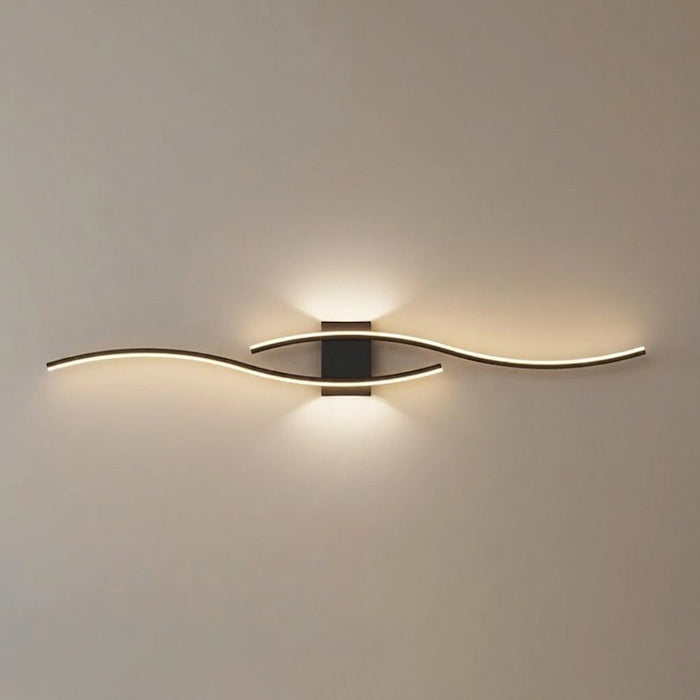 Modern wall light fixture in a living room setting with a gray sofa.