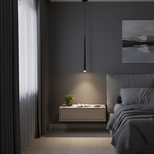 Modern bedroom with a nightstand, lamp, and artwork on a dark wall.