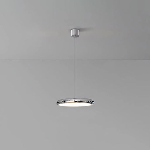 Modern pendant light hanging from a ceiling on a gray background
