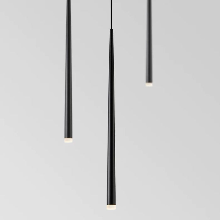 Three black pendant lights on a gray background