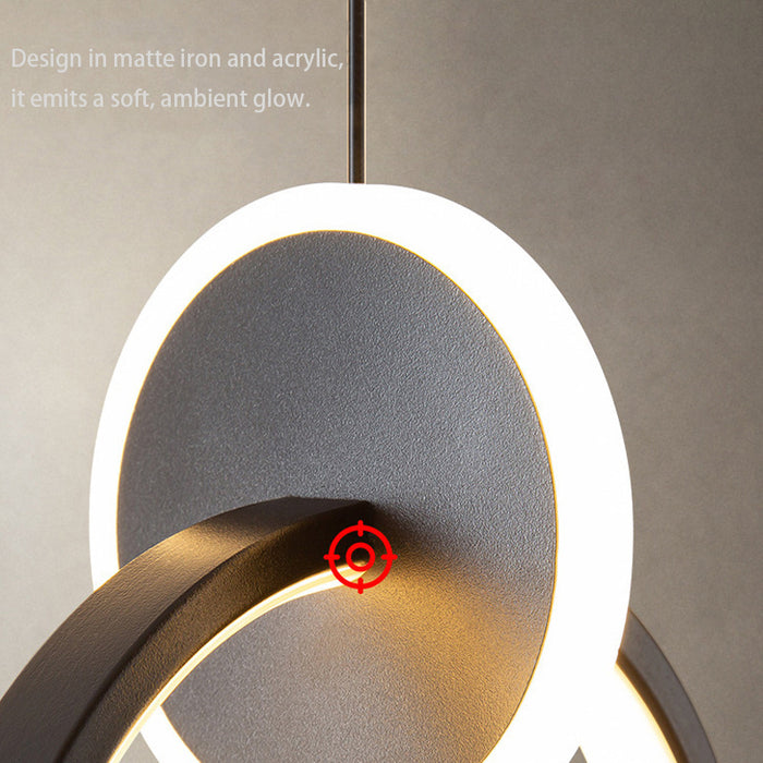 Modern wall light fixture with a red target design on a neutral background