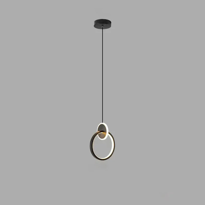 Modern pendant light with circular design on a gray background