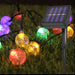 Colorful string lights with a solar panel on grass