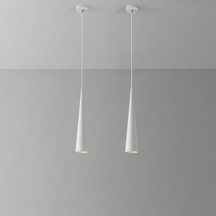 Two pendant lights hanging from a gray ceiling