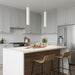 Modern kitchen with white island, wooden stools, and stainless steel appliances.