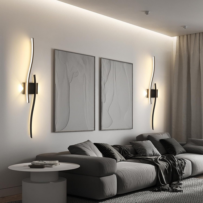 Modern living room with a gray sectional sofa, wall art, and decorative items.