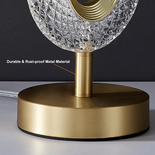 Gold table lamp with crystal shade on a dark background