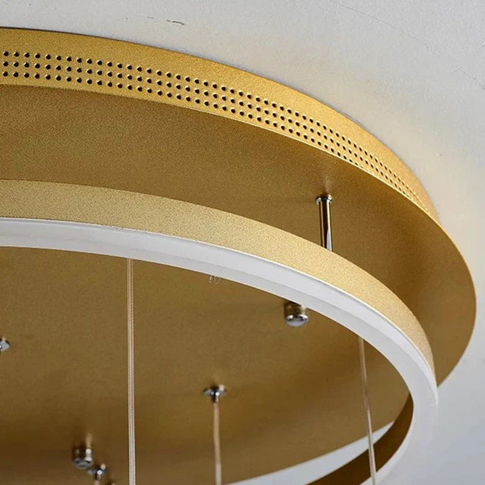 Close-up of a gold circular ceiling light fixture with white interior