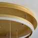 Close-up of a gold circular ceiling light fixture with white interior