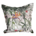 Decorative pillow with tropical leaf and flower pattern on a white background